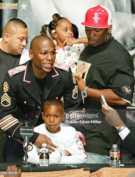 Floyd Mayweather Jr. Holds his son Koraun Mayweather while rapper 50 Cent holds Mayweather's daughter Iyanna Mayweather during a news conference...