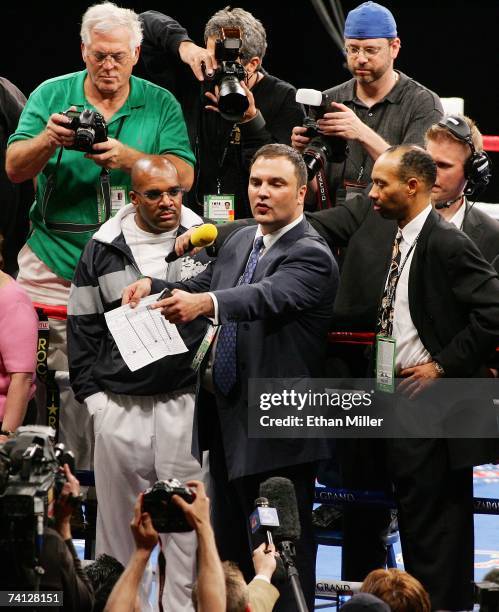 Floyd Mayweather Jr.'s manager Leonard Ellerbe looks on as Golden Boy Promotions CEO Richard Schaefer talks to members of the media about what he...