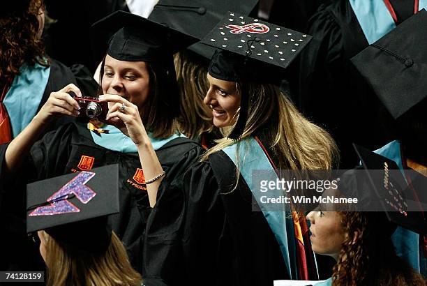 Virginia Tech graduate student displays a memorial ribbon on the top of her mortarboard cap during commencement exercises for graduate students at...