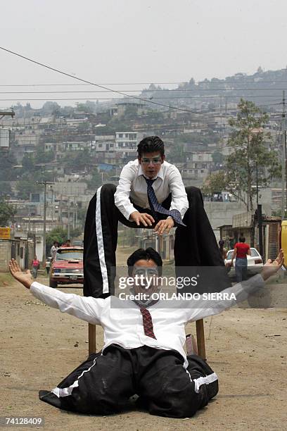 Bryan Cordova y Wilber Lorenzana participan en una demostracion de zancos en el asentamiento Mario Alioto Lopez, el mas grande de Centro America,...