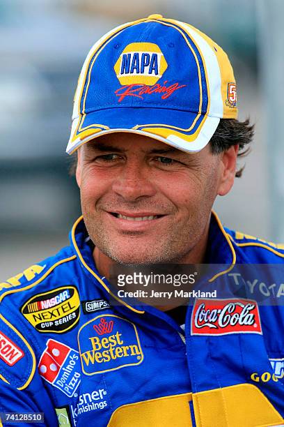 Michael Waltrip, driver of the NAPA Toyota, smiles while standing on pit road during qualifying for the NASCAR Nextel Cup Series Dodge Avenger 500 on...