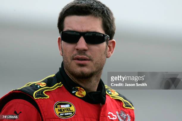 Martin Truex Jr., driver of the Bass Pro Shops/Tracker Chevrolet, stands on pit road during qualifying for the NASCAR Nextel Cup Series Dodge Avenger...