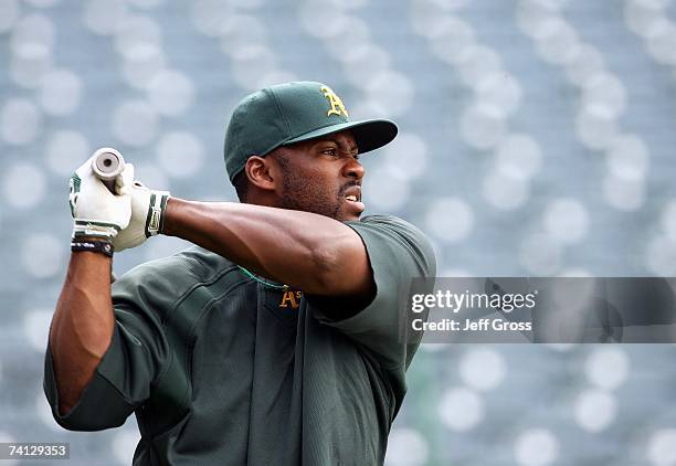 Milton Bradley of the Oakland Athletics swings in batting practice before the game against the Los Angeles Angels of Anaheim at Angel Stadium on...