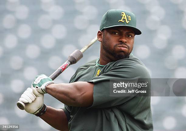 Milton Bradley of the Oakland Athletics swings in batting practice before the game against the Los Angeles Angels of Anaheim at Angel Stadium on...