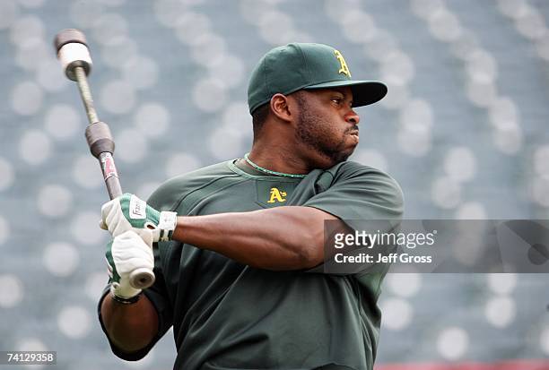 Milton Bradley of the Oakland Athletics swings in batting practice before the game against the Los Angeles Angels of Anaheim at Angel Stadium on...