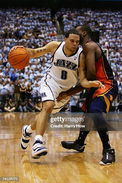 Deron Williams of the Utah Jazz drives to the basket against Baron Davis of the Golden State Warriors in Game Two of the Western Conference...