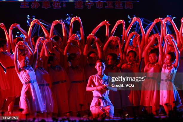 Nurses and doctors perform during a show to mark the upcoming International Nurses' Day, May 10, 2007 in Suining, southwest China's Sichuan Province.