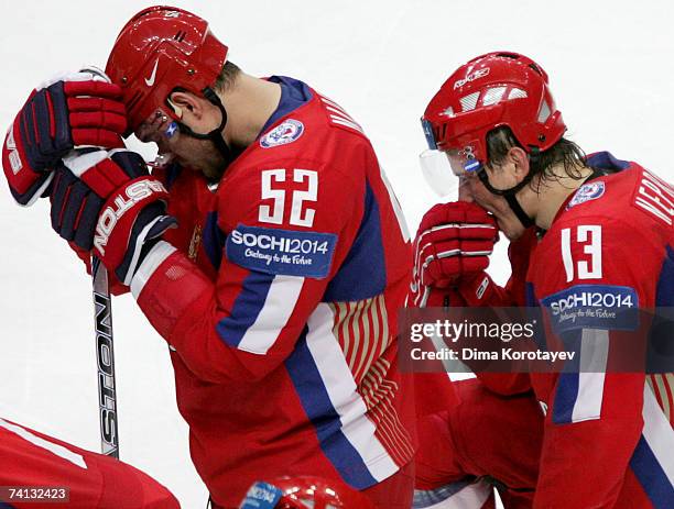 Russia's Ivan Nepryaev and Andrey Markov react after losing the IIHF World Ice Hockey Championship semi-final match between Russia and Finland at the...