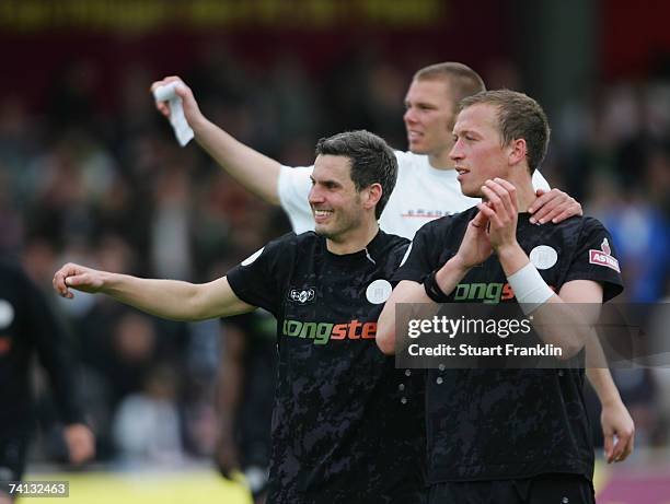 Thomas Meggle and Marcel Eger of St. Pauli celebrate promotion at the end of the Third League Northern Division match between FC St.Pauli and Fortuna...