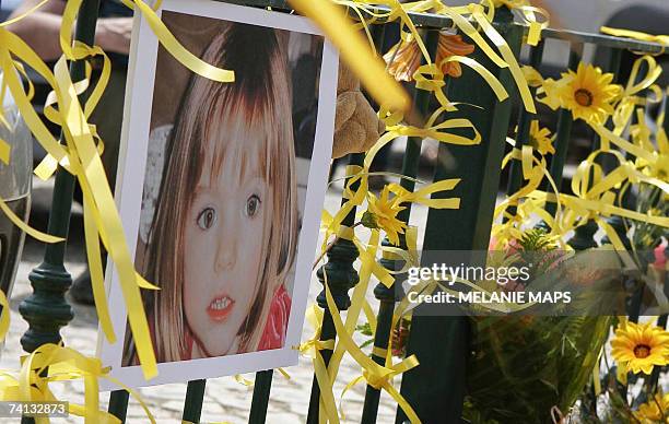 Yellow ribbon, candles and a picture of Madelaine McCann are seen on the railings outside the reception of the Ocean Club in Praia da Luz, Portugal,...