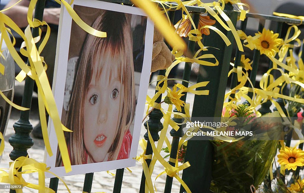 Yellow ribbon, candles and a picture of...