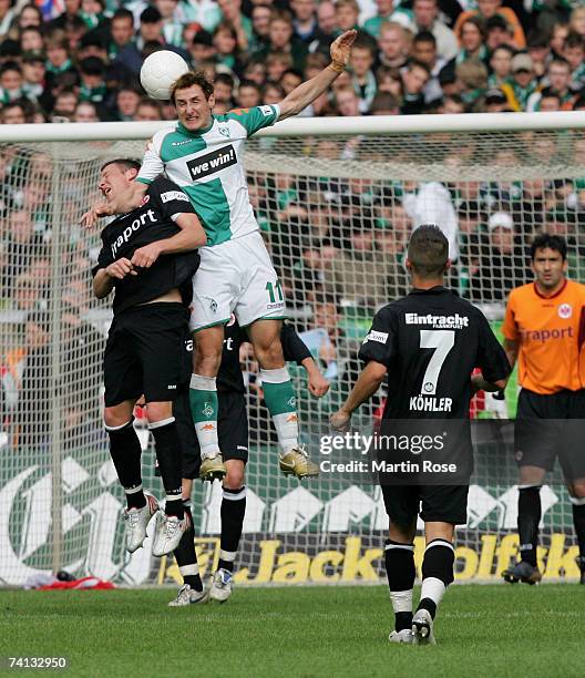 Michael Fink of Frankfurt and Miroslav Klose of Bremen go up for a header during the Bundesliga match between Werder Bremen and Eintracht Frankfurt...