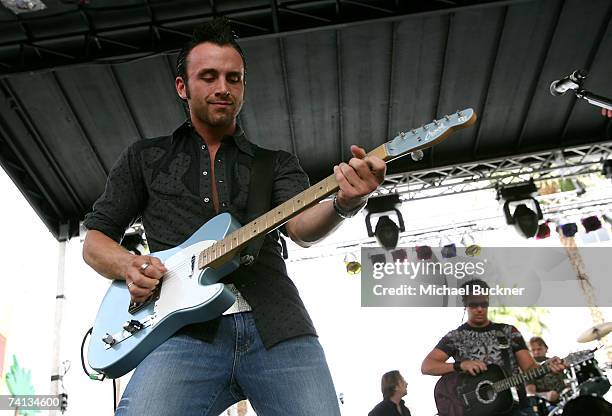 Musicians Dave Cramer and Chris "Abby" Abbondanza of the band "PovertyNeck Hillbillies" perform onstage during day one of the Academy of Country...