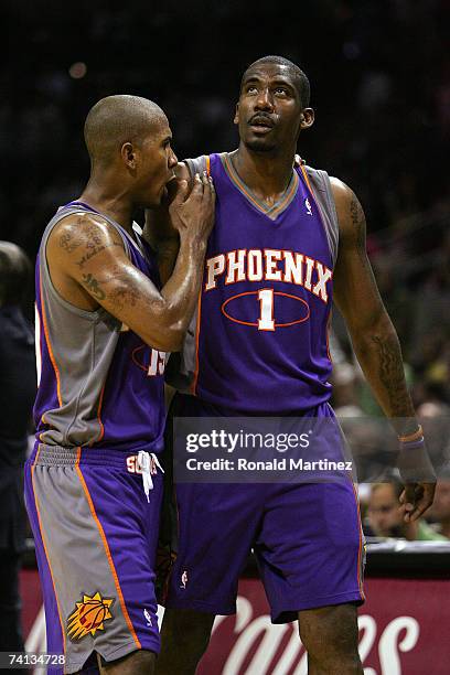 Guard Raja Bell of the Phoenix Suns talks with Amare Stoudemire after he received his second foul against San Antonio Spurs in the first quarter in...