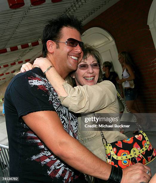 Musician Chris "Abby" Abbondanza of the band "PovertyNeck Hillbillies" hugs a fan during day one of the Academy of Country Music All Star Concert at...