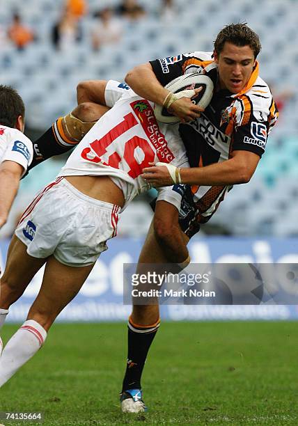 Dean Collis of the Tigers is tackled during the round nine NRL match between the Wests Tigers and the St George Illawarra Dragons at Telstra Stadium...