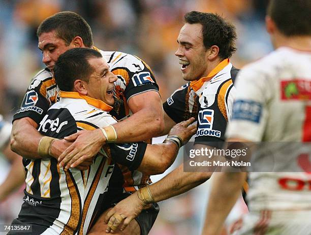 Chris Heighinton and Liam Fulton of the Tigers congratulates Ben Galea after he scored during the round nine NRL match between the Wests Tigers and...