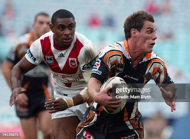 John Morris of the Tigers looks to offload during the round nine NRL match between the Wests Tigers and the St George Illawarra Dragons at Telstra...