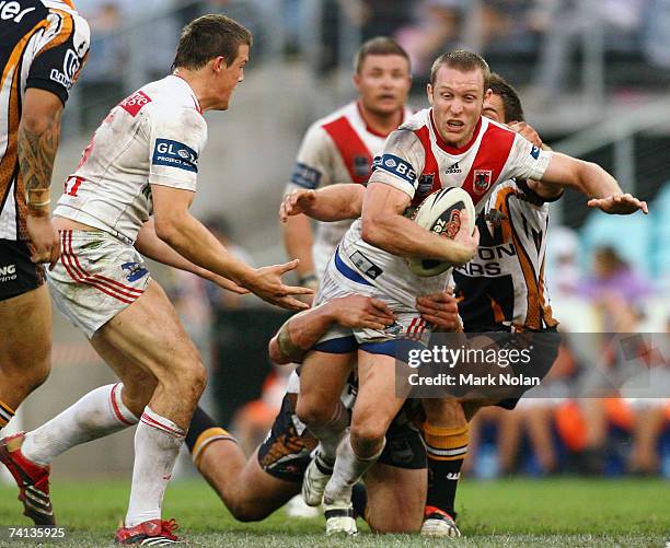 Ben Hornby of of the Dragons is tackled during the round nine NRL match between the Wests Tigers and the St George Illawarra Dragons at Telstra...