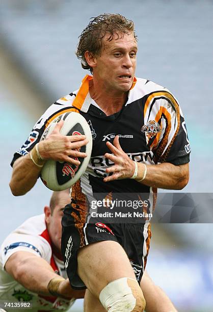 Brett Hodgson of the Tigers makes a line break during the round nine NRL match between the Wests Tigers and the St George Illawarra Dragons at...