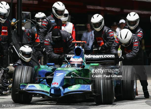 Jenson Button of Great Britain and Honda Racing is given a push by his team mechanics after a pitstop during the Spanish Formula One Grand Prix at...
