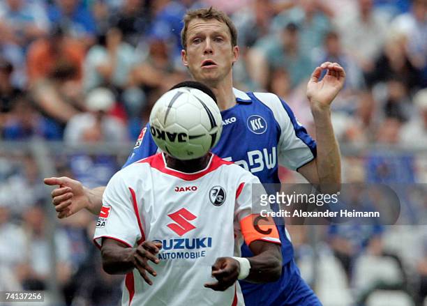 Micahel Mutzel of Karlsruhe competes with Soumaila Coulibaly of Freiburg during the Second Bundesliga match between Karlsruher SC and SC Freiburg at...