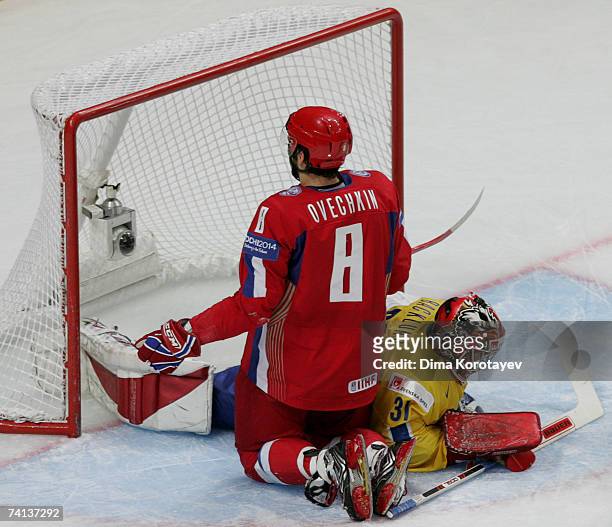 Russia's Alexander Ovechkin fights for the puck with Sweden's Johan Backlund during the IIHF World Ice Hockey Championship bronze medal match between...