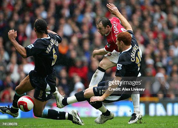 Anton Ferdinand and James Collins of West Ham United stretch to block the shot of Wayne Rooney of Manchester United during the Barclays Premiership...