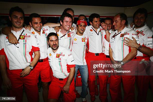 Felipe Massa of Brazil and Ferrari celebrates with team mates in the paddock after winning the Spanish Formula One Grand Prix at the Circuit de...