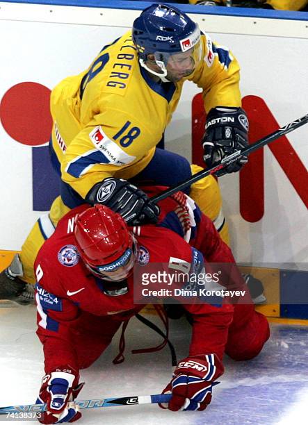 Russia's Alexander Ovechkin fights for the puck with Sweden's Per Hallberg during the IIHF World Ice Hockey Championship bronze medal match between...