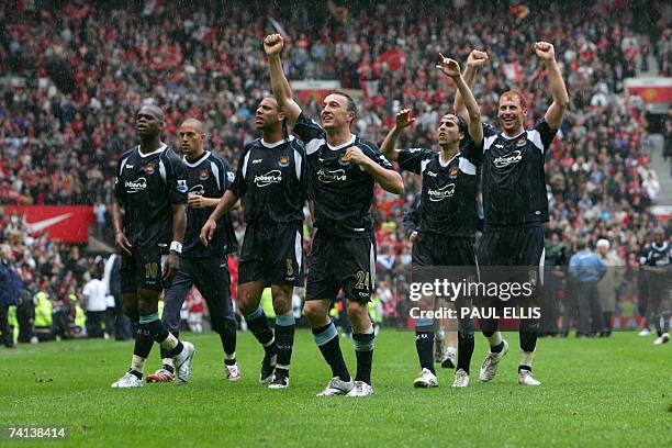 Manchester, UNITED KINGDOM: West Ham salute their fans after victory against Manchester United saves them from relegation, during their English...