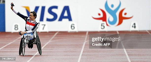 Manchester, UNITED KINGDOM: Tanni Grey-Thompson waves to the crowd after her last ever race in the T53 200 meters during the Visa Paralympic world...