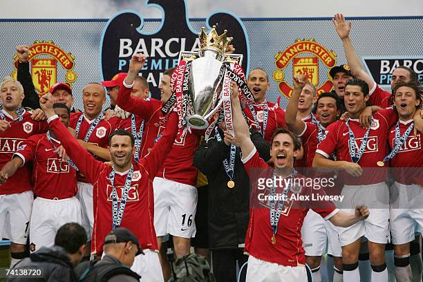 Ryan Giggs and Gary Neville of Manchester United lift the Premiership trophy as their team celebrate winning the Premiership title at the end of the...