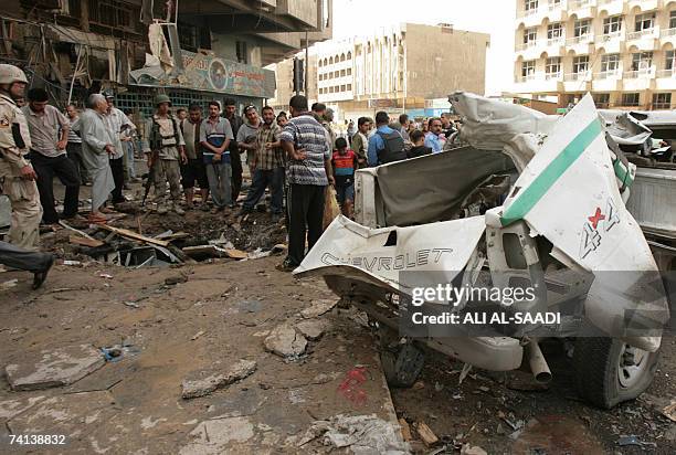 Iraqis gather at the site of a powerful explosion which erupted 13 May 2007 in a central Baghdad market, ripping through a crowded district that has...