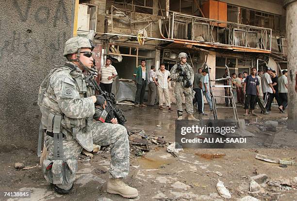 Soldiers guard the site of a powerful explosion which erupted 13 May 2007 in a central Baghdad market, ripping through a crowded district that has...