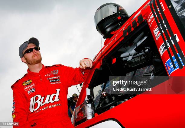 Dale Earnhardt Jr., driver of the Budweiser Chevrolet, stands next to his car prior to the NASCAR Nextel Cup Series Dodge Avenger 500 on May 13, 2007...