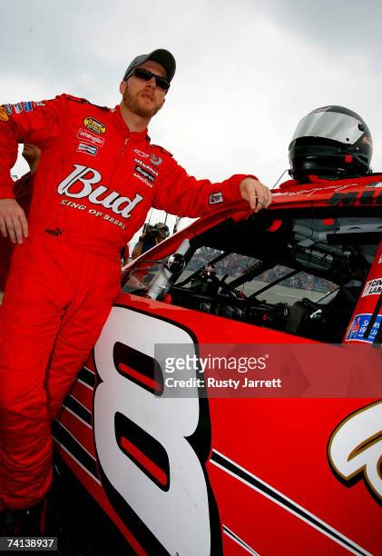 Dale Earnhardt Jr., driver of the Budweiser Chevrolet, stands next to his car prior to the NASCAR Nextel Cup Series Dodge Avenger 500 on May 13, 2007...