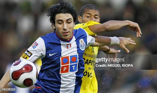 Porto's uruguayan Jorge Fucile vies with Pacos Ferreira's Angolan Edson Nobre during their portuguese Super League football match at the Mata Real...