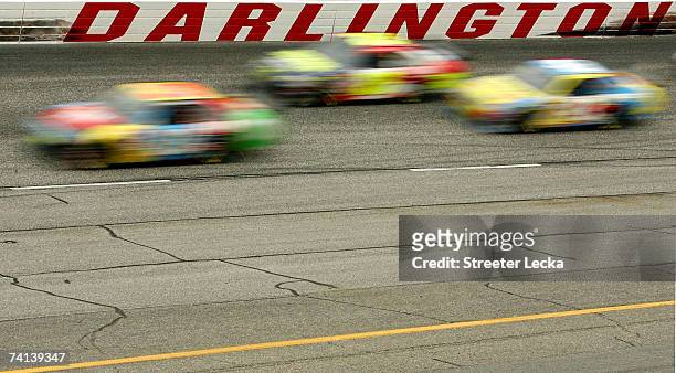 View of cars racing on the track during the NASCAR Nextel Cup Series Dodge Avenger 500 on May 13, 2007 at Darlington Raceway in Darlington, South...