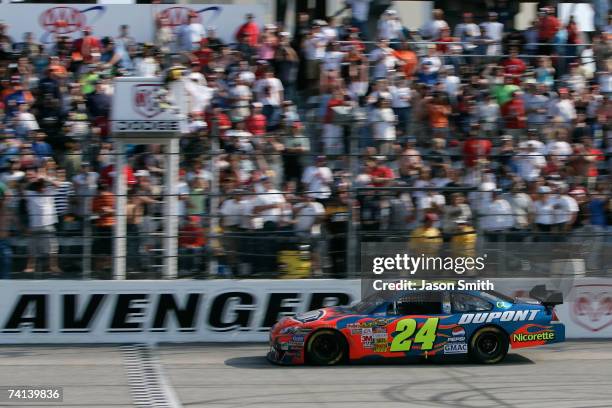 Jeff Gordon, driver of the DuPont Chevrolet, comes to the finish line to win the NASCAR Nextel Cup Series Dodge Avenger 500 on May 13, 2007 at...