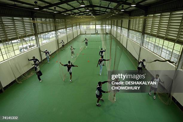 Chittagong, BANGLADESH: Indian cricketers stretch before an indoor nets session at the stadium in Chittagong, 14 May 2007. The Indian team are...