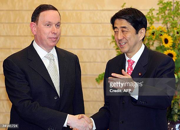 Michael M. Kaiser , Kennedy Center president shakes hands with Japanese Prime Minister Shinzo Abe at the Prime Minister's official residence in...