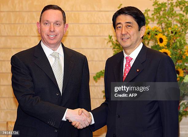 Michael M. Kaiser , Kennedy Center president shakes hands with Japanese Prime Minister Shinzo Abe at the Prime Minister's official residence in...