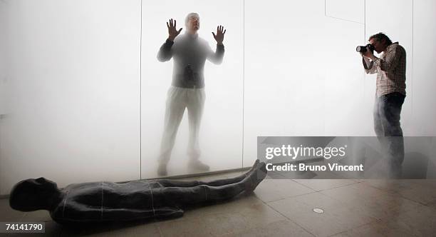 Anthony Gormley poses for photographers within his 'Blind Light' installation at the Hayward Gallery on May 14, 2007 in London. Oscillating...