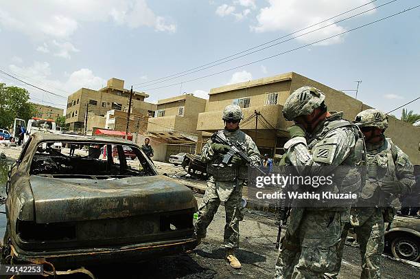 Soldiers secure the site of a car bomb explosion on May 14, 2007 in Karrada Shiite neighborhood in Baghdad, Iraq. A car bomb exploded at a parking...