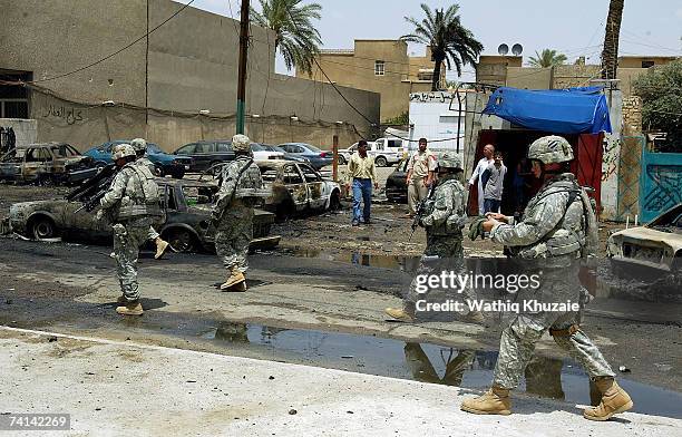 Soldiers arrive at the site of a car bomb explosion on May 14, 2007 in Karrada Shiite neighborhood in Baghdad, Iraq. A car bomb exploded at a parking...