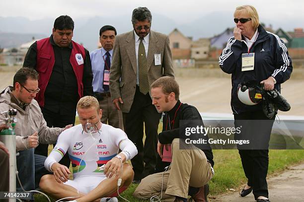 Chris Hoy of Great Britain takes on oxygen assisted by Doctor Kenneth Baillie as his mother Carol Hoy nervously looks on after his failed attempt to...