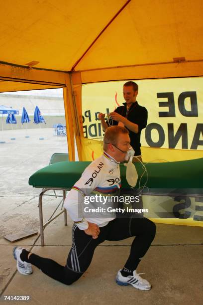 Chris Hoy of Great Britain, watched by Doctor Kenneth Baillie,stretches in preparations before his failed attempt to break the World 1 Kilometre...