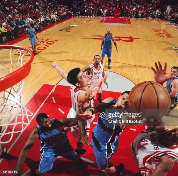 Deron Williams of the Utah Jazz takes goes for a layup between Yao Ming and Shane Battier of the Houston Rockets in Game Seven of the Western...