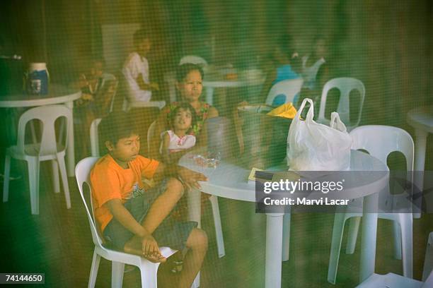 Families deemed by sponsoring NGOs as toxic waste victims spend a day retreat at a public pool, June 1, 2006 in Angeles, Pampanga. The families were...